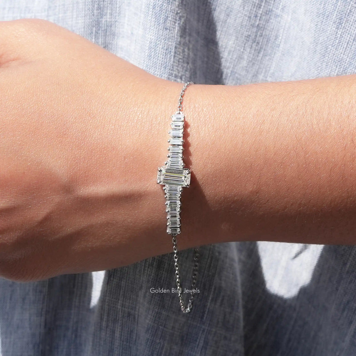 View of moissanite emerald cut with baguette tennis Bracelet