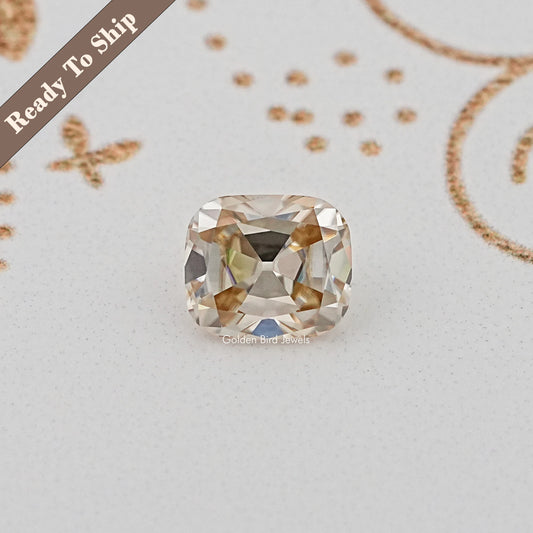 Cushion-cut loose gemstone with golden tones, faceted