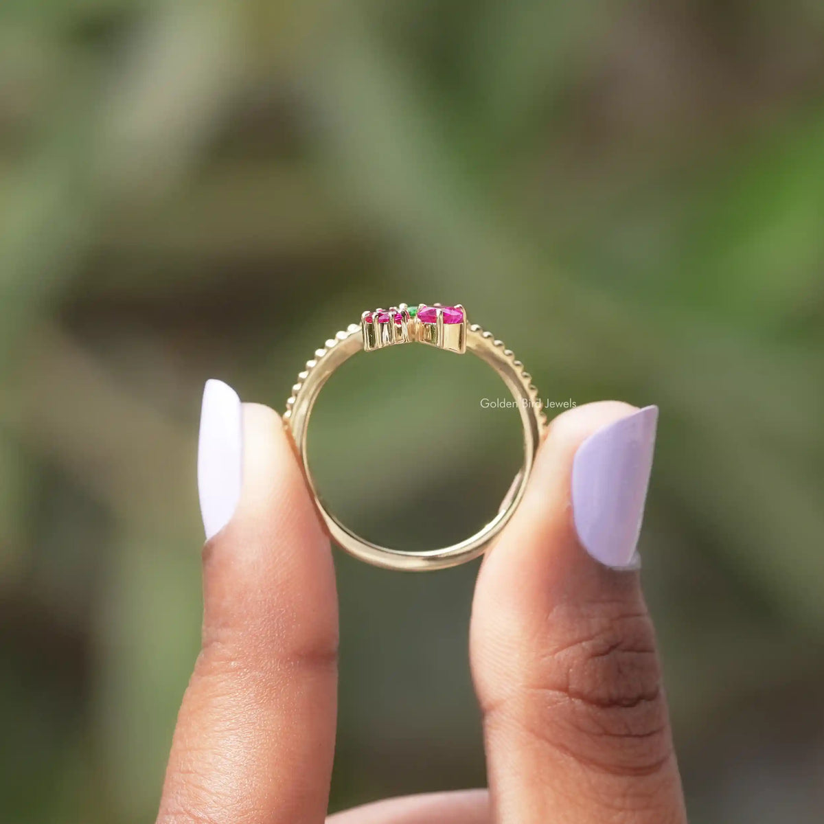 Back View of Heart Cut And Round Gemstone Ring In two fingers