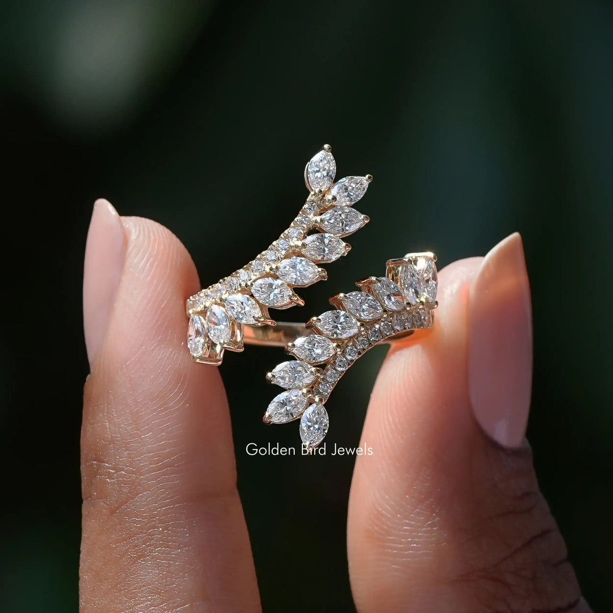 Two fingers holding the Marquise Cut Diamond Bypass Ring
