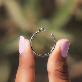 Back View of Green Marquise Cut Accent Stone Ring In two fingers