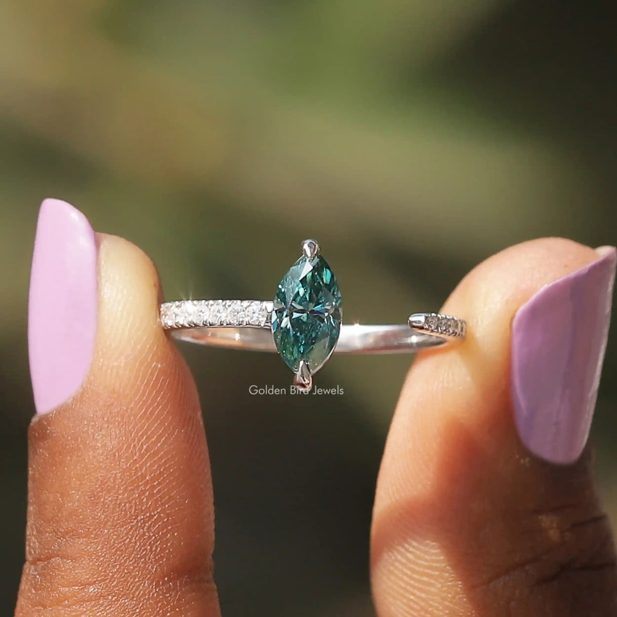 Two fingers holding the Marquise Cut Moissanite Open Cuff Accent Stone Ring