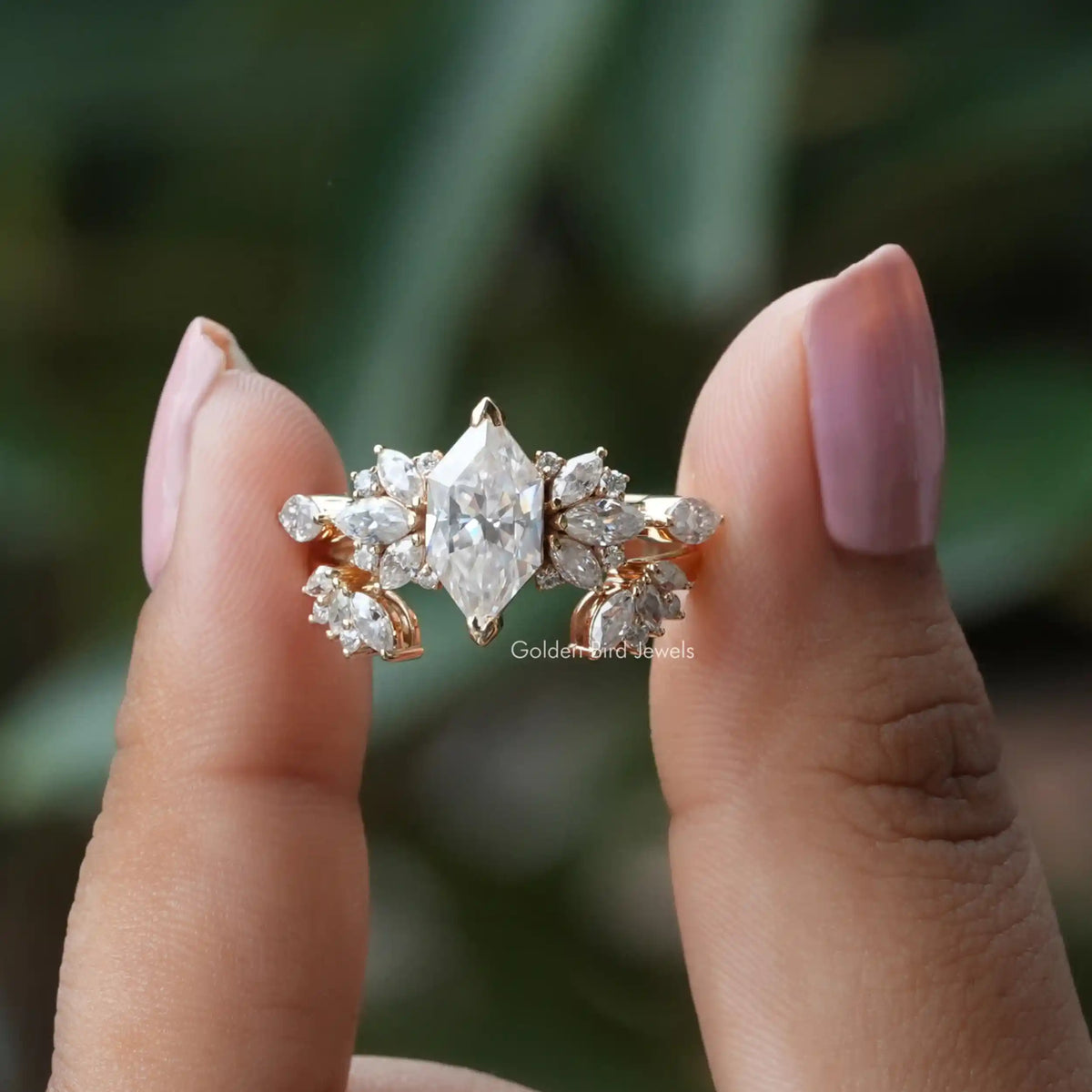 Two fingers holding the Dutch Marquise Cut Moissanite Ring 