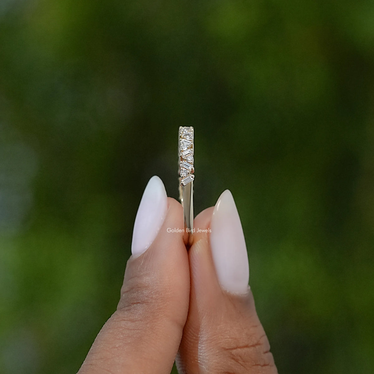 Vertical close-up of gold-tone lab diamond baguette half eternity band ring