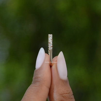 Vertical close-up of gold-tone lab diamond baguette half eternity band ring