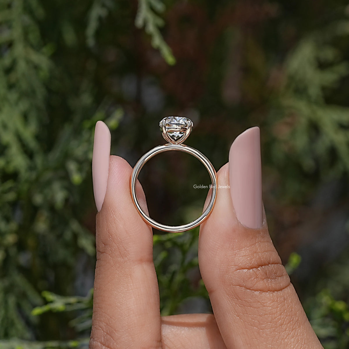 Gold-tone oval moissanite ring with prong-set stone and open round band
