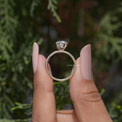 Gold-tone oval moissanite ring with prong-set stone and open round band
