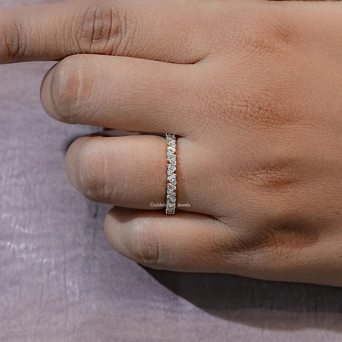 Gold-tone lab diamond half eternity band ring on finger, straight baguette sparkle