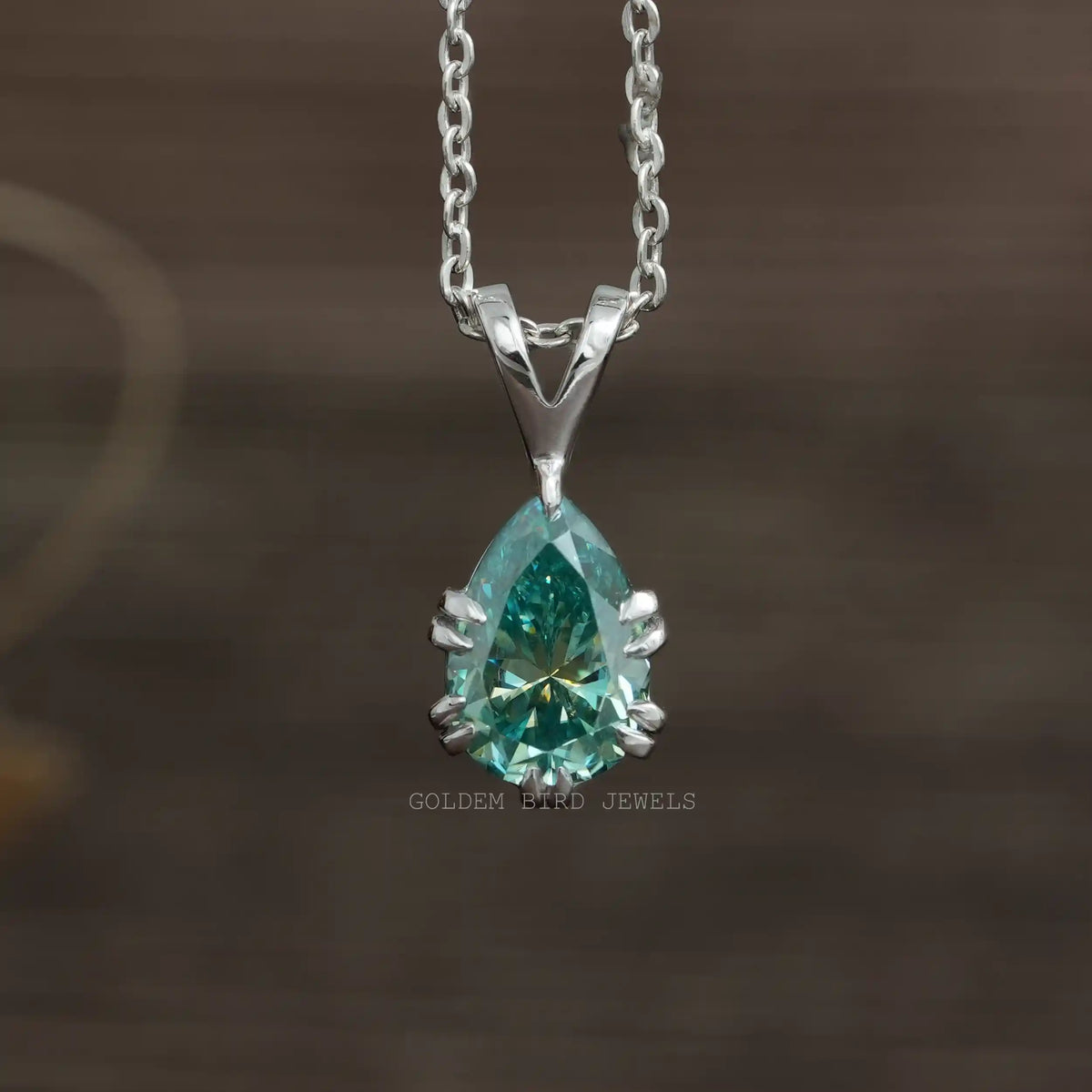 Front view of blue pear cut moissanite pendant in 