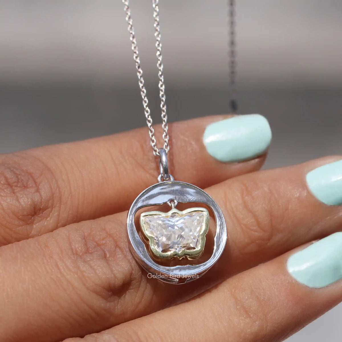 In hand showing view of moissanite pendant	 		