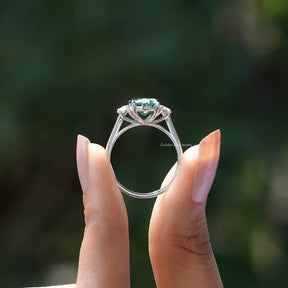 Back View of Oval And Half Moon Three Stone Ring In two fingers