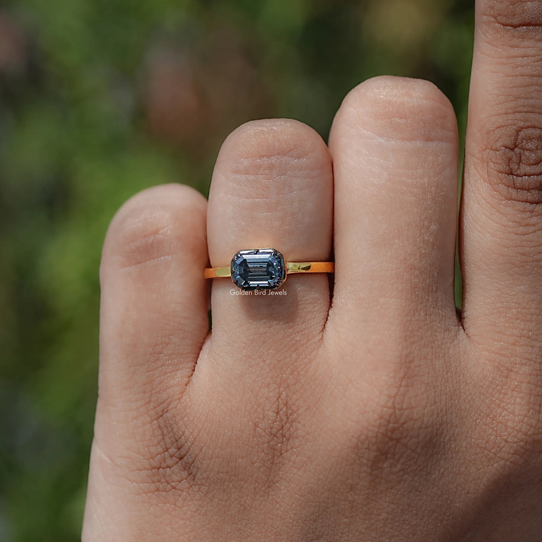 In finger view of East West Cut Moissanite Solitaire Ring