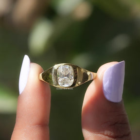 Two fingers holding the Elongated Old Mine Cushion Ring