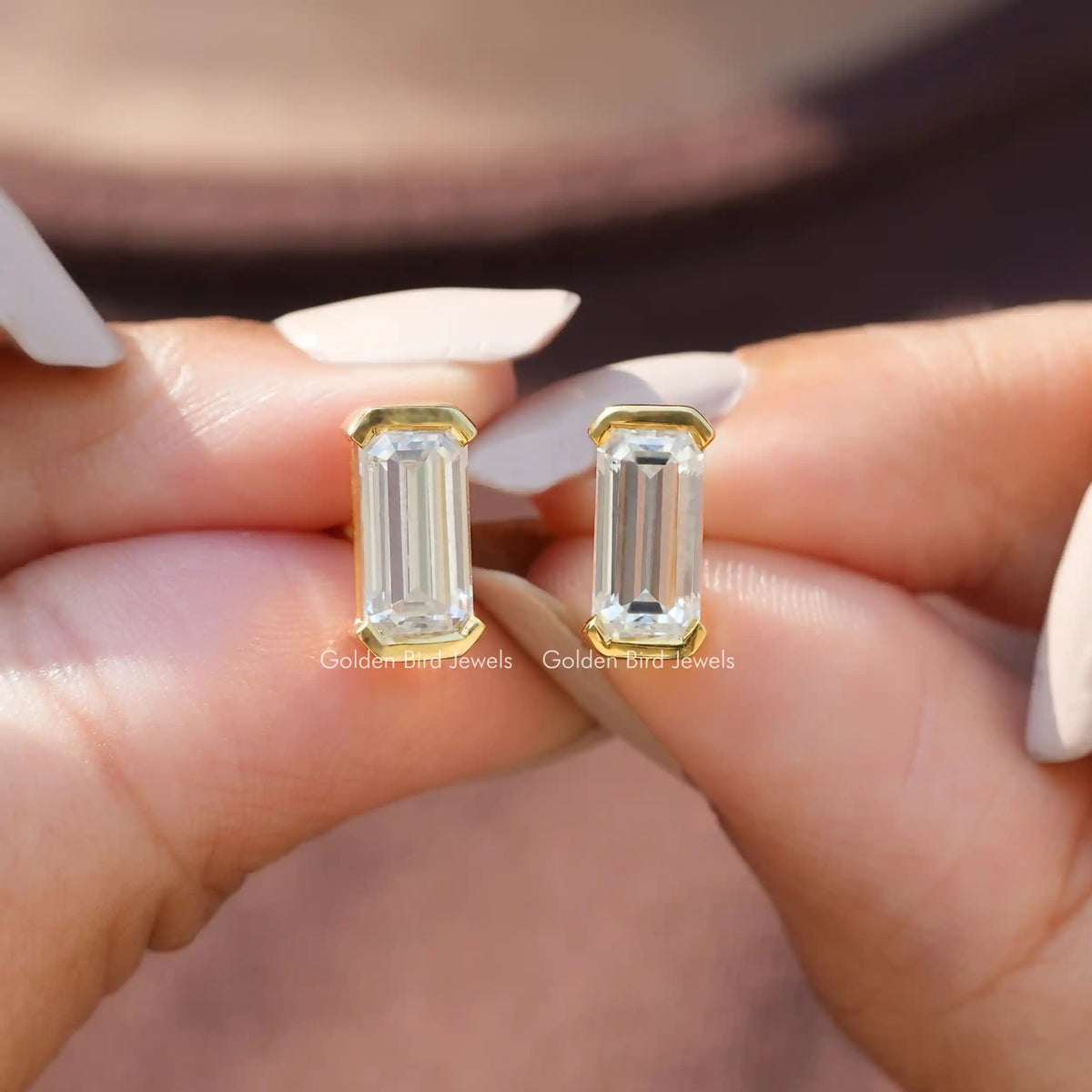 Front view of colorless emerald cut moissanite earrings