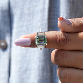 In finger front View of Emerald Cut Three Stone Ring In White Gold