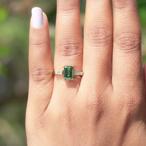 Close-Up View of Emerald Cut Moissanite Engagement Ring In Yellow Gold