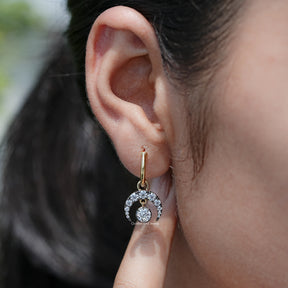 Detailed view of Old European Round Moissanite Dangle Hoop Earrings in secure setting 