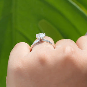 Side View of OEC Round Cut Moissanite Ring In two fingers