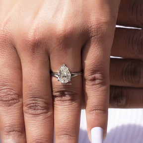 Top view of moissanite engagement ring in pear shape for women 's wear
