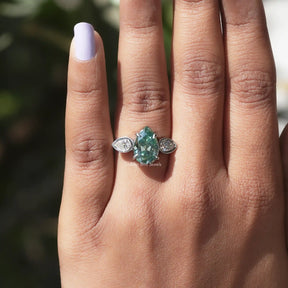 View of Old Mine Pear Cut 3 Stone Ring In finger
