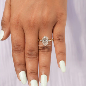 Close-Up View of Moissanite Oval Cut Accent Stone Ring In Yellow Gold       