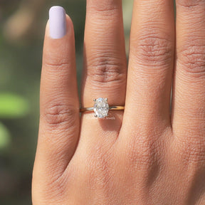 Detailed View Of Oval Cut Hidden Halo Engagement Ring In Yellow Gold