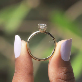 Back View of Oval Cut Moissanite Hidden Halo Ring In two fingers