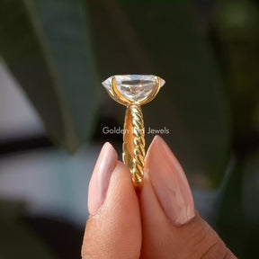 Side View of Oval Cut Solitaire Moissanite Ring In two fingers