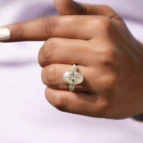 Detailed View Of Three Stone Oval And Pear Cut Moissanite Ring In Yellow Gold