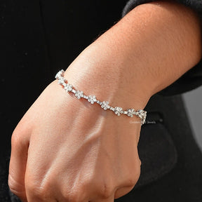 In hand showing view of moissanite floral bracelet