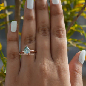 View of Blue Green Pear Cut Moissanite Ring In Finger