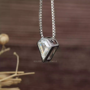 Side view of colorless pentagon cut pendant set in bezel setting