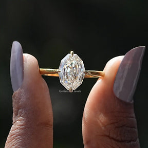 Two fingers holding the Step Cut Oval Hidden Halo Engagement Ring