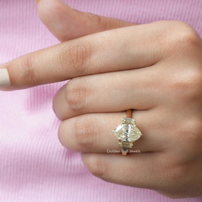 Top view of three-stone moissanite   ring in yellow gold