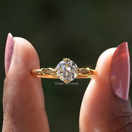 Gold-tone round moissanite solitaire ring with small side accents, sterling silver