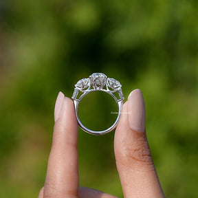 Back View of Round And Tapered Baguette Cut Five Stone Engagement Ring In two fingers