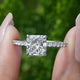 Square Radiant Cut Diamond Solitaire Ring Held Between Fingers