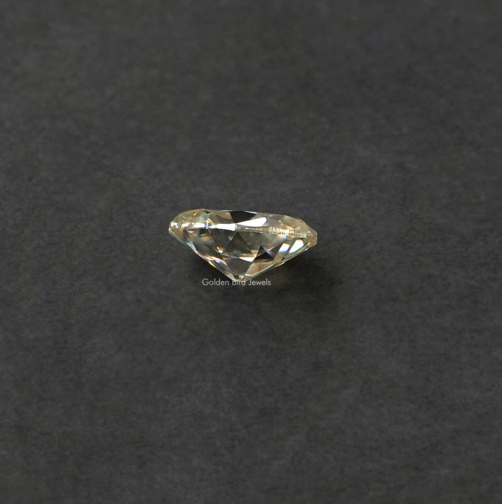 Side view of off white old mine oval cut moissanite 