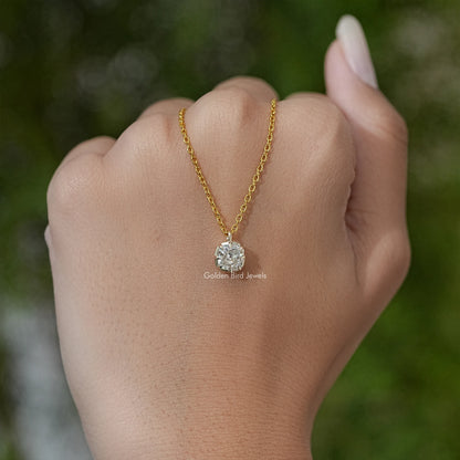 Round cushion-cut moissanite pendant on gold tone chain, shown on open palm