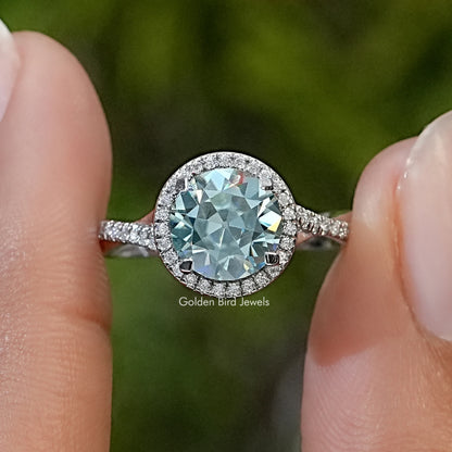 Round moissanite halo ring with twisted pavé band in sterling silver