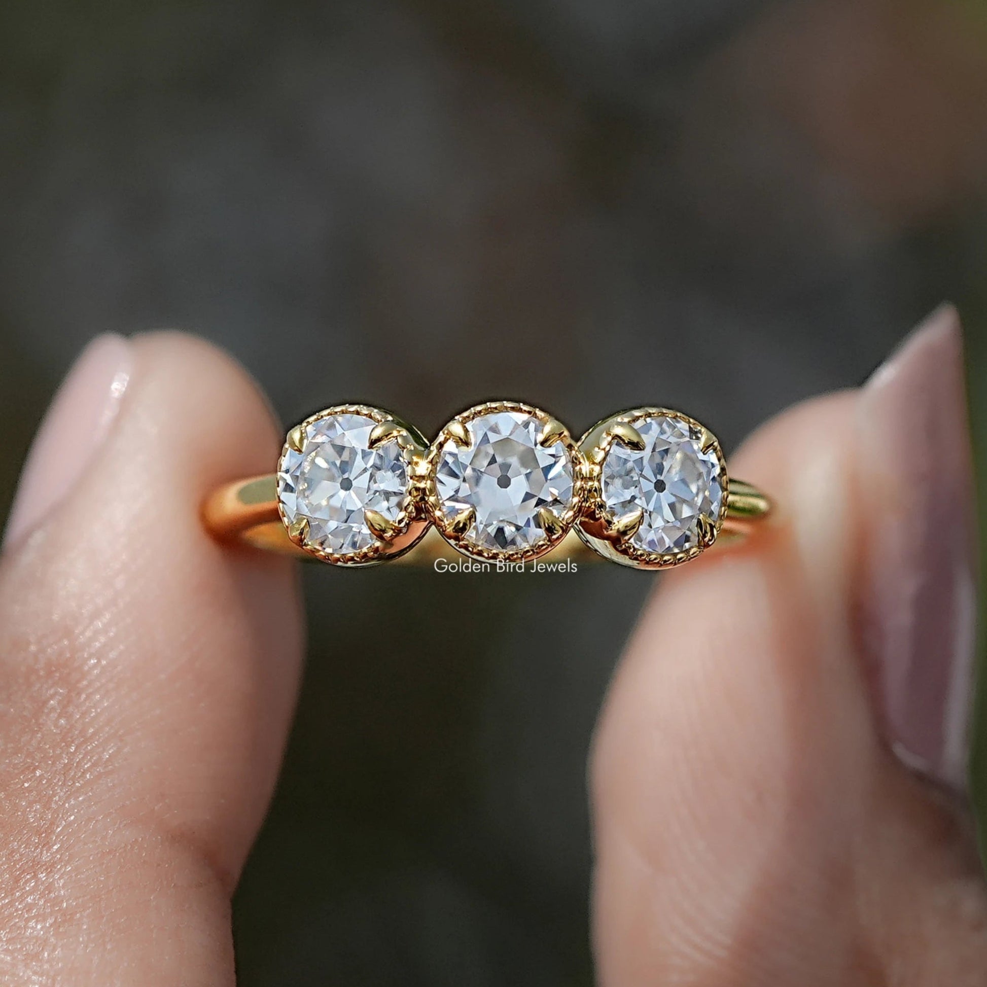 Front view of Old European Cut Round Moissanite Three Stone Ring