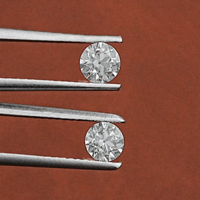 Tweezer holding the Old European Round Diamond Matching Pair