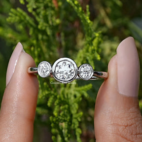 Front View of Old European Round Cut Diamond Three Stone Ring In two Fingers