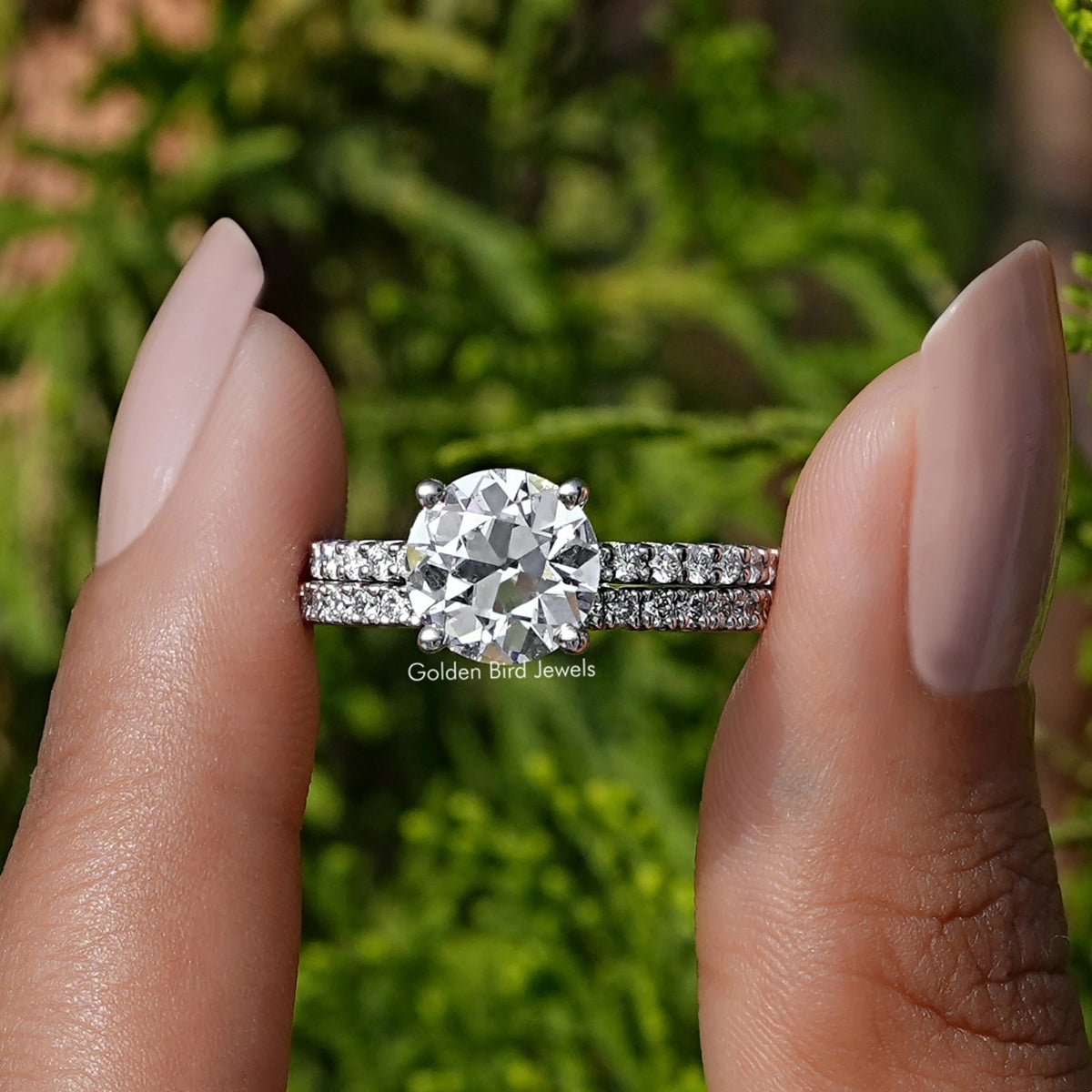 Front view of A Old  Round Diamond Ring in two fingers