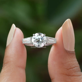 Front View of Old European Round Cut Three Stone Ring In two Fingers