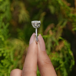 Side View of Cushion And Heart Moissanite Toi Et Moi Ring In two fingers