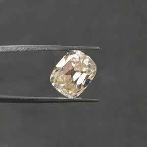 Tweezer view of Old Mine cushion Cut Loose moissanite