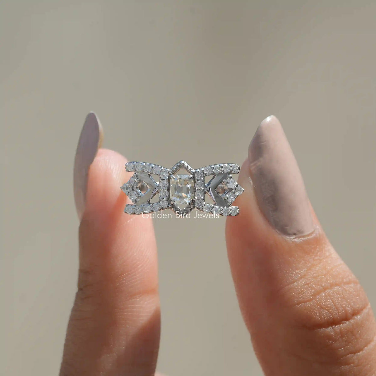 Front View of Old Mine Cushion Cut Moissanite Engagement Ring In two Fingers