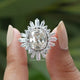 Two fingers holding the Old Mine Cushion Cut Moissanite Halo Engagement Ring 