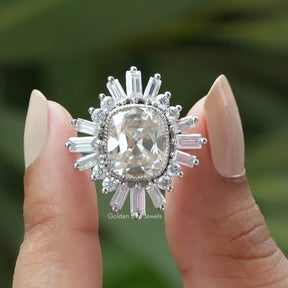 Two fingers holding the Old Mine Cushion Cut Moissanite Halo Engagement Ring 